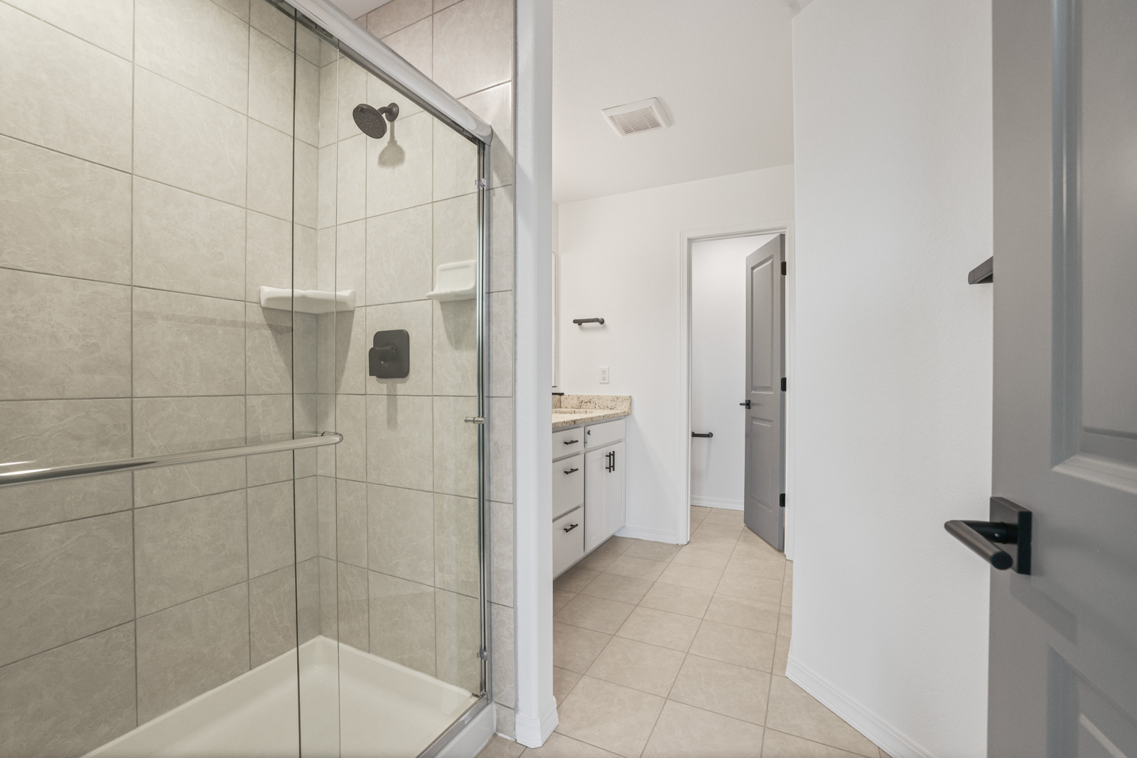 Lander primary bathroom with tile shower and vanity