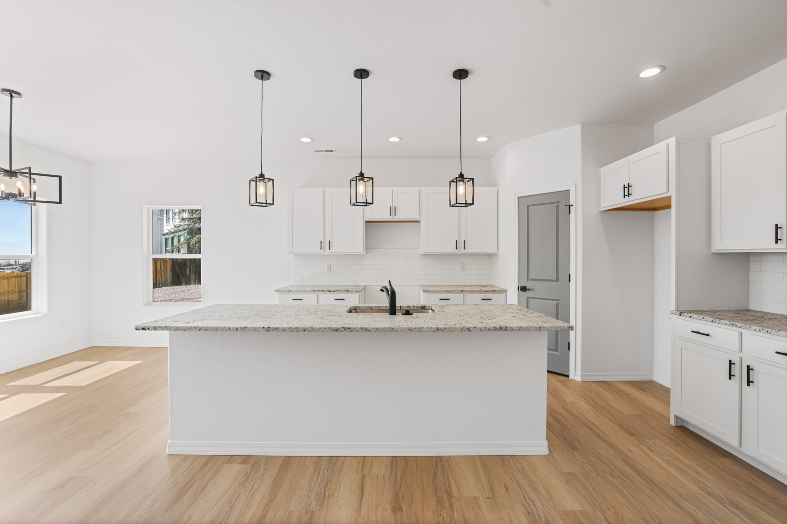 Lander kitchen with granite island, pendant lighting and LVP flooring