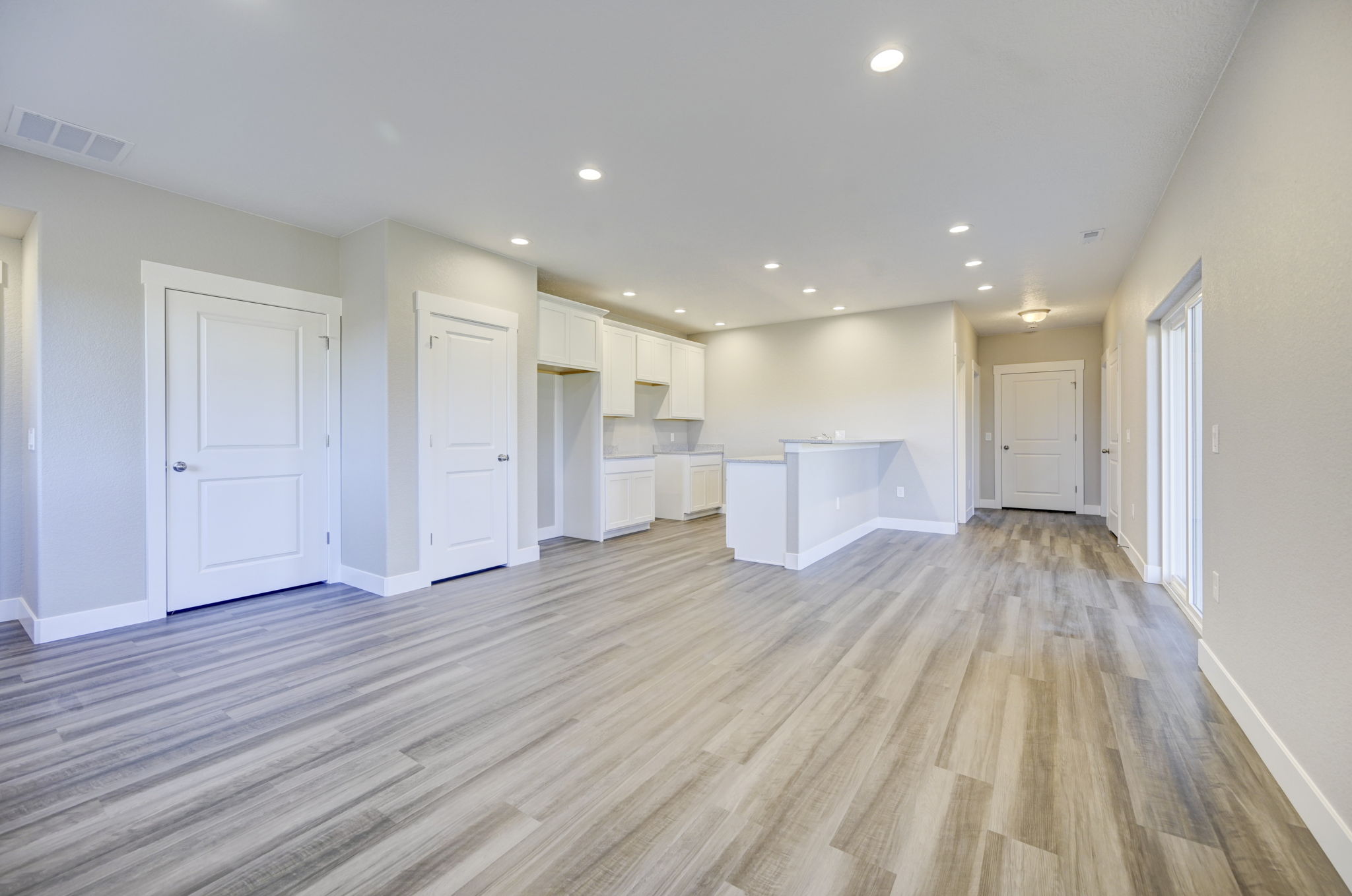 Snowwood kitchen with white cabinetry and granite countertops